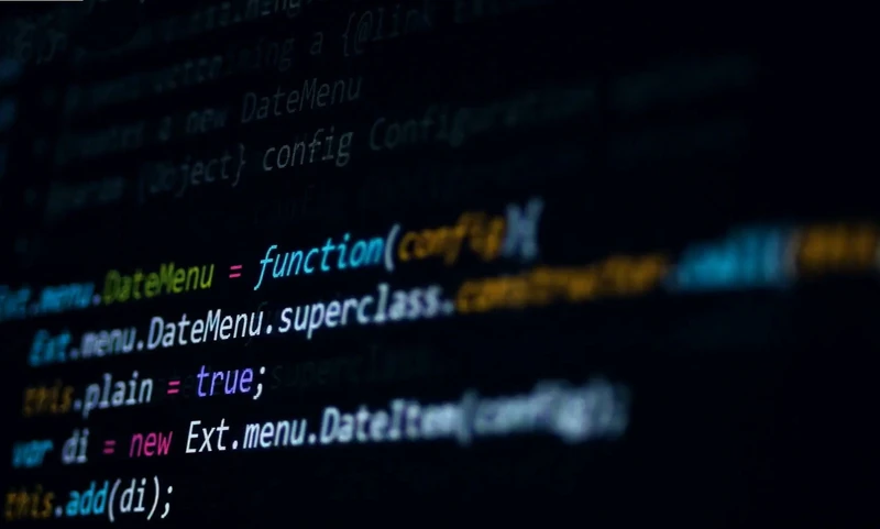 A close-up view of a computer screen displaying colorful lines of JavaScript code on a dark background, reminiscent of an efficient warehouse system managing the seamless flow of fulfillment orders and boxes.